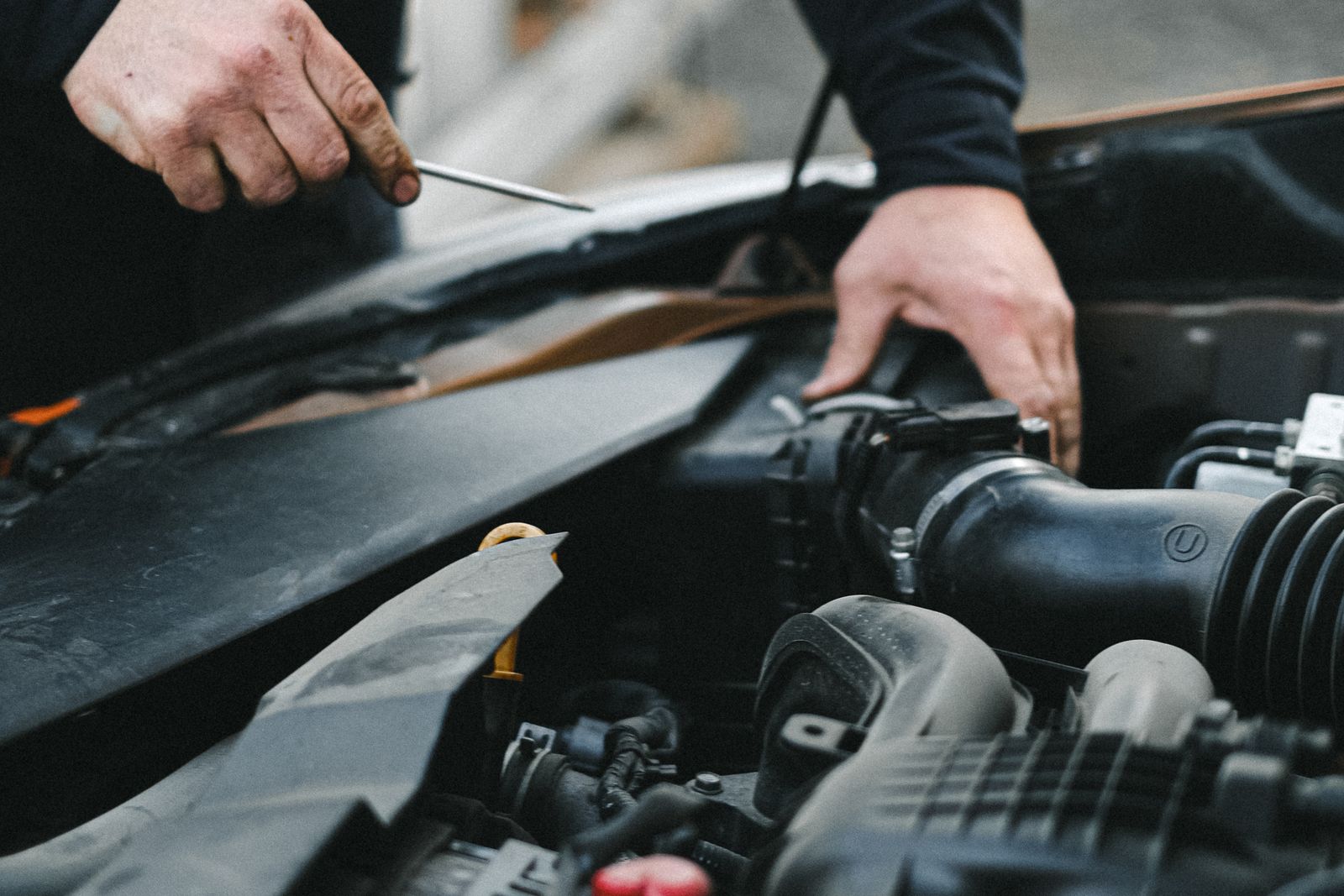 A mechanic working on a vehicle engine in the shop
